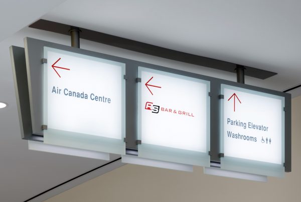 Ceiling sign arrows pointing to Air Canada Centre, Bar & Grill and Parking Elevator